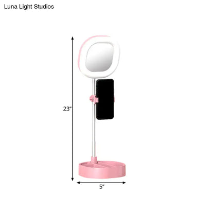 Pink and white led mirror light vanity with phone holder designed for bedroom use with simple light blue led illumination