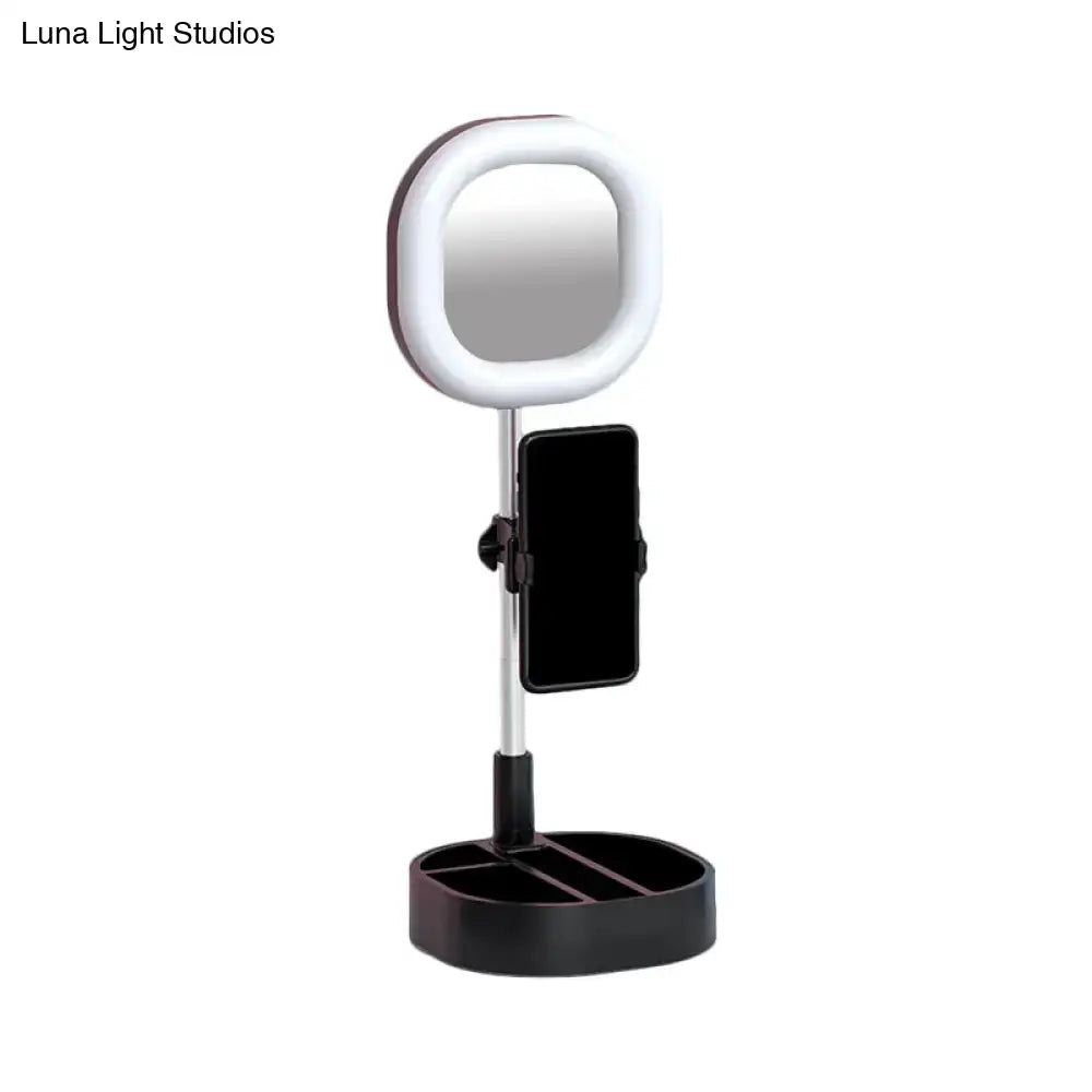 A sleek black and white led mirror light vanity mirror with phone holder, adjustable stand, and multi-compartment base