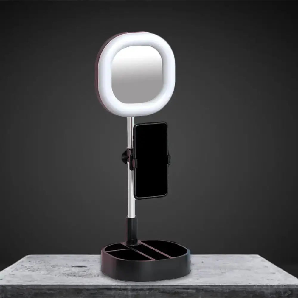A sleek modern vanity led mirror light with white ring light and black base featuring a phone holder for bedroom use