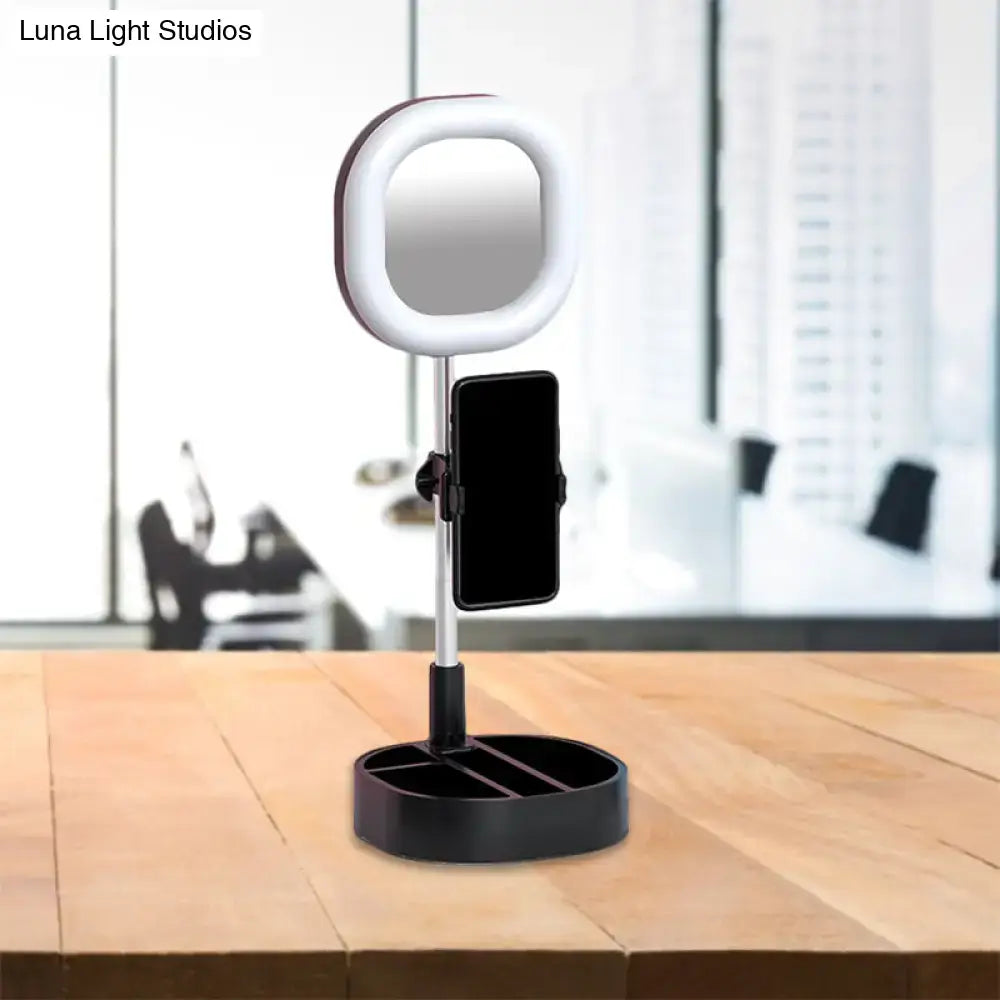 White ring light vanity mirror with black base and phone holder featuring led mirror light for bedroom use