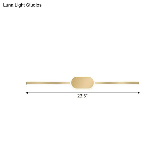 A sleek gold metallic wall mounted vanity sconce with a simple style and oval central accent for bedroom use