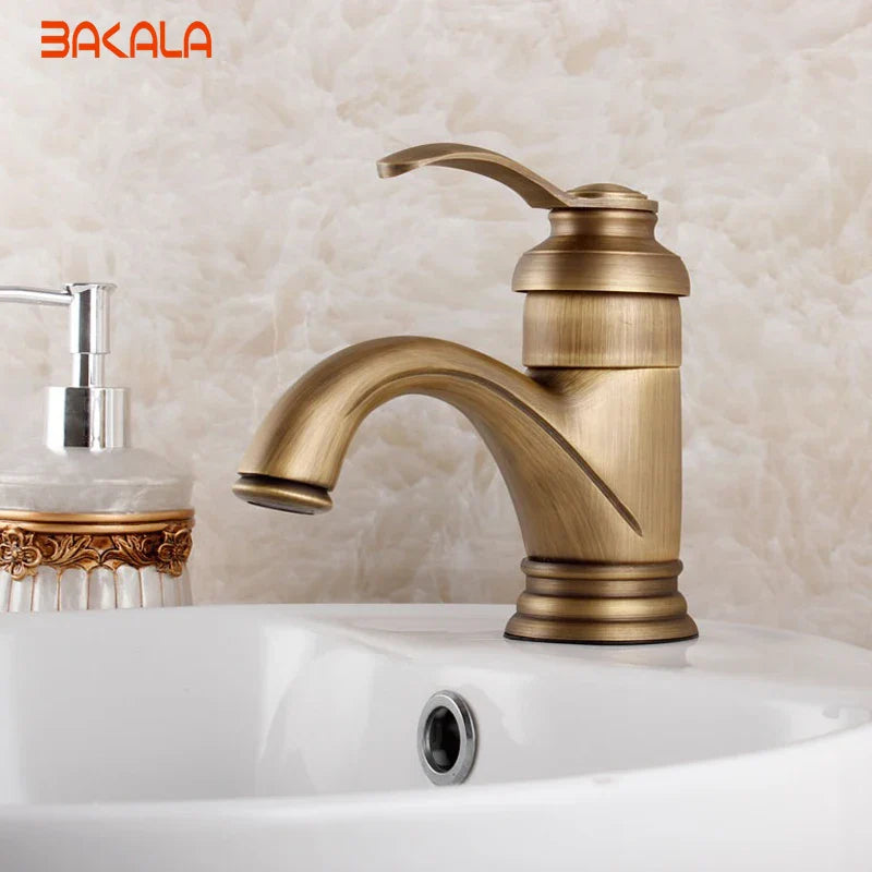 Antique brass single hole deck mounted bathroom faucet with single handle curved spout and decorative ridged base