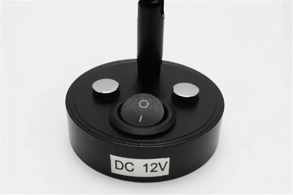Black circular base with two silver buttons and power switch labeled dc 12v on the back of a sleek black led reading lamp