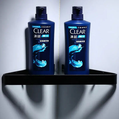 Two dark blue plastic men’s shampoo bottles on a sleek decorbites black aluminum glass shelf bathroom storage rack