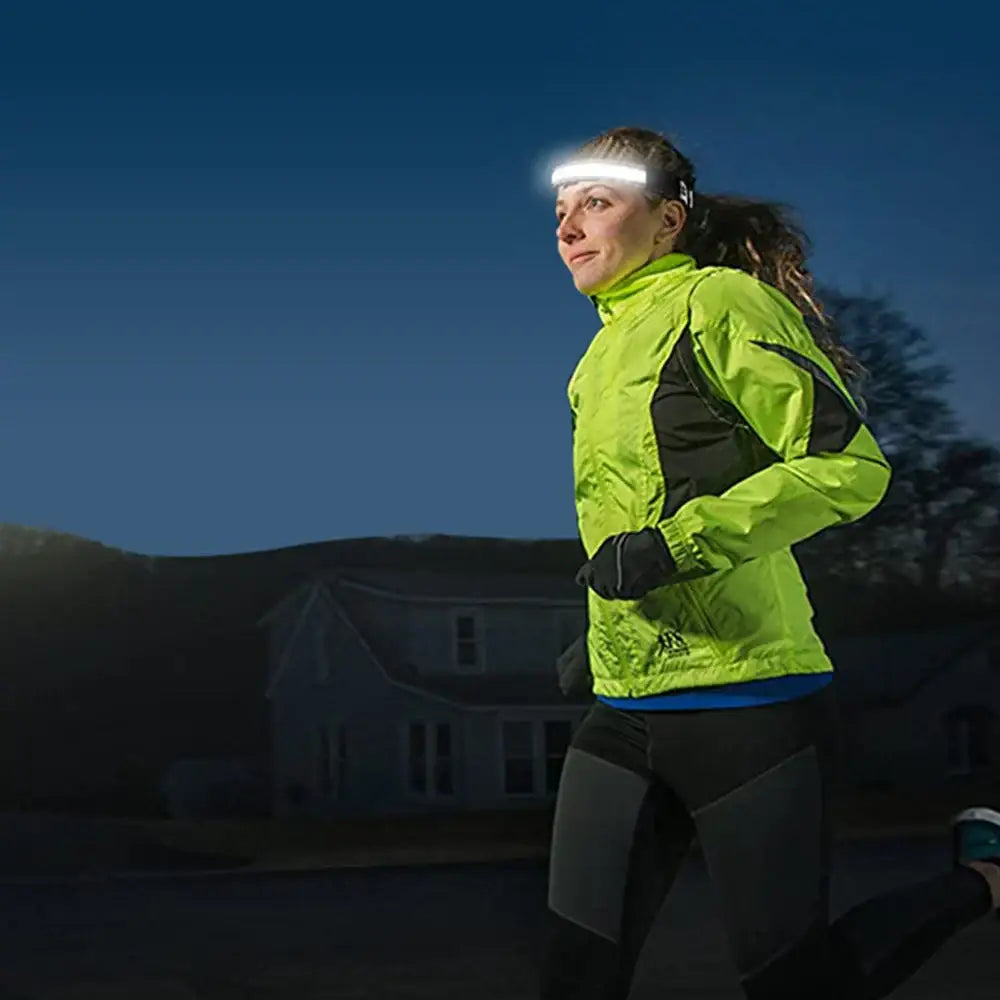 A bright neon green cob led sensor headlamp with a sleek adjustable band worn by a runner for hands free use