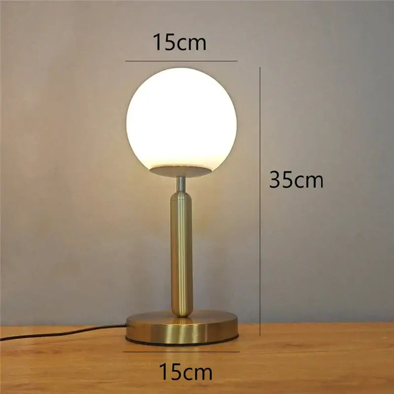 A sleek brass glass ball table lamp with frosted globe shade ideal for bedroom decorbites glass ball lighting