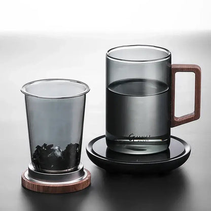 Sleek dark gray double walled glass tea cup with wooden handle lid and matching saucer for modern tea serving