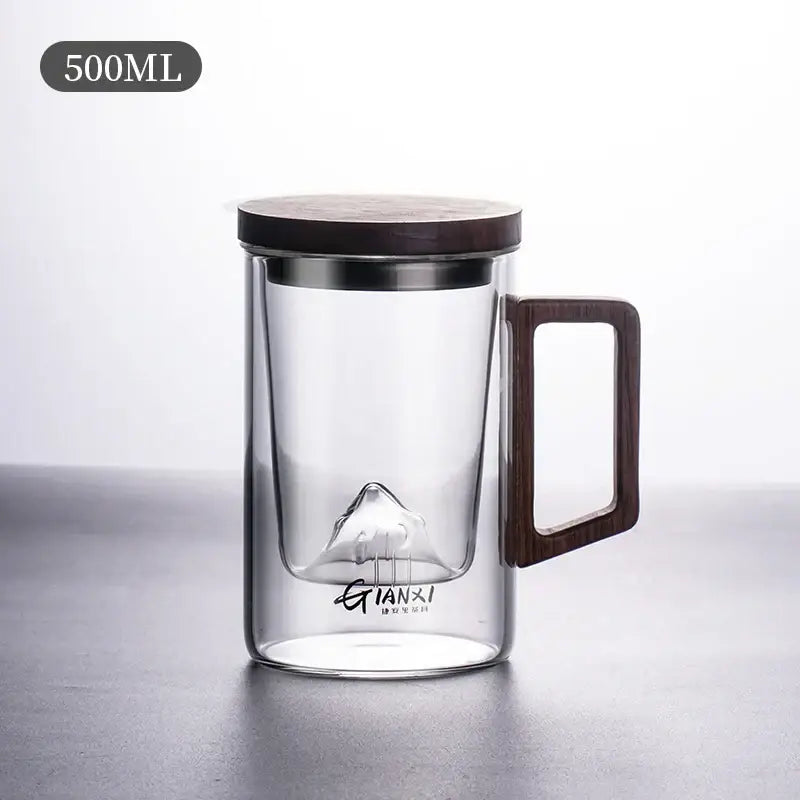 Sleek dark gray double walled glass tea cup with wooden lid and engraved mountain design at the base