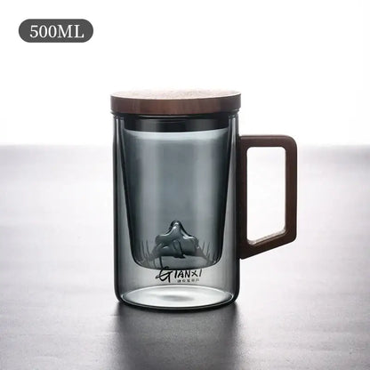 Sleek dark gray double walled glass tea cup with wooden lid and handle featuring a mountain shaped infuser