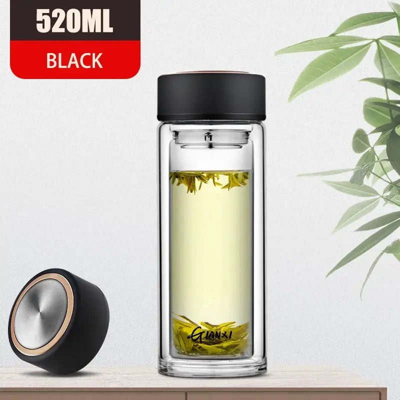520ml black double-walled glass water bottle with sleek lid and silver accent filled with green tea leaves for kitchen use