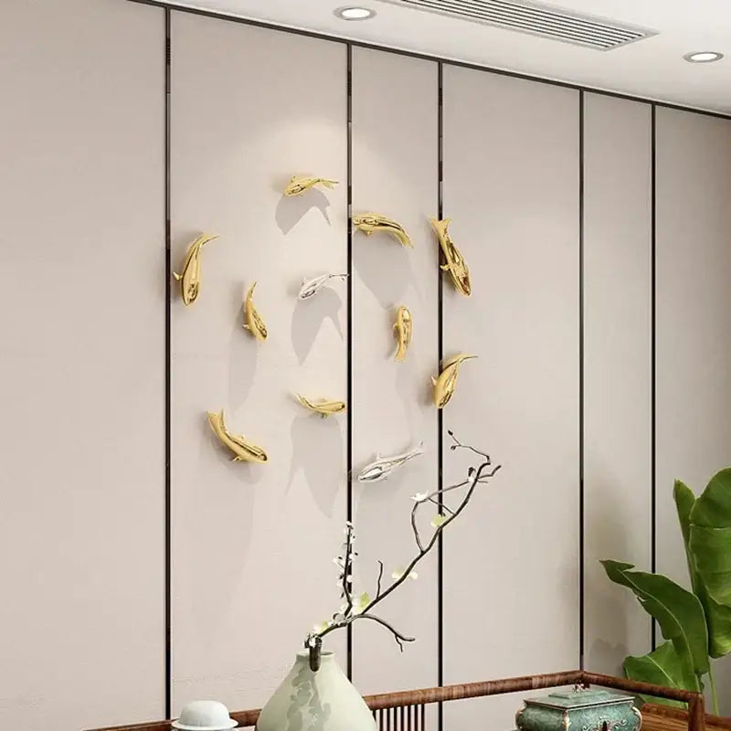 Sleek goldfish resin wall hanging in gold and silver colors for living room decor by decorbites goldfish resin wall