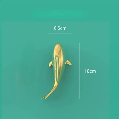 Golden metallic fish-shaped decorbites goldfish resin wall hanging measuring 18cm long and 6.5cm wide for living room decor