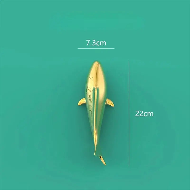 A sleek golden dolphin-shaped decorbites goldfish resin wall hanging with a glossy finish for living room decor