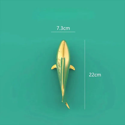 A sleek golden dolphin-shaped decorbites goldfish resin wall hanging with a glossy finish for living room decor