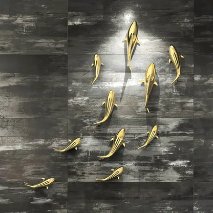Sleek goldfish resin wall hanging with metallic gold finish and streamlined design for elegant living room decorbites goldfish resin decor