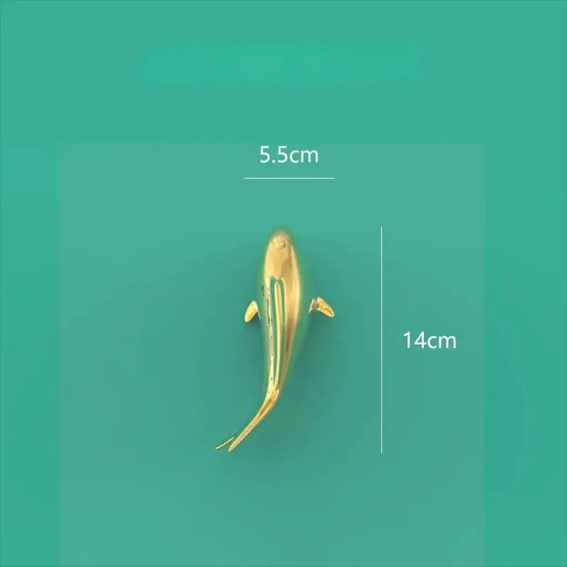 A sleek goldfish resin wall hanging with a polished golden metallic finish and detailed fins for living room decorbites decor