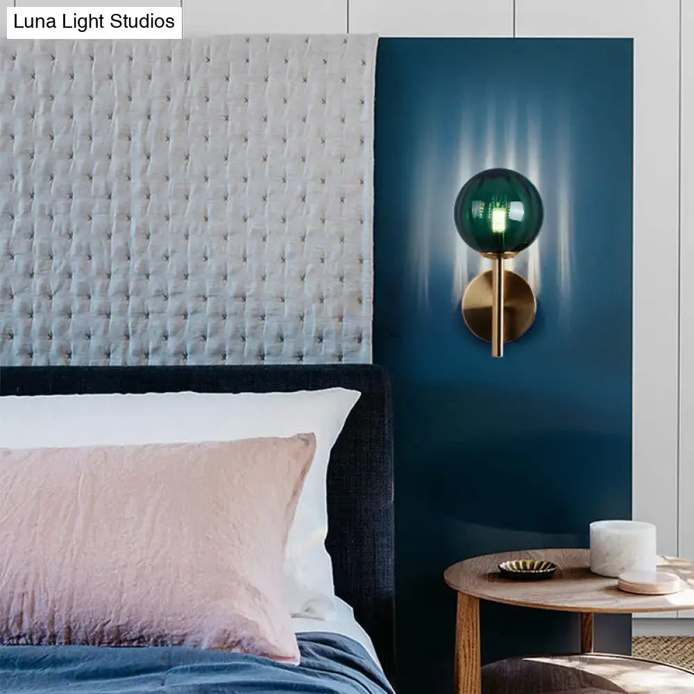 Emerald green spherical glass wall sconce with brass metal base as round wall lighting bedside sconce light in red green amber