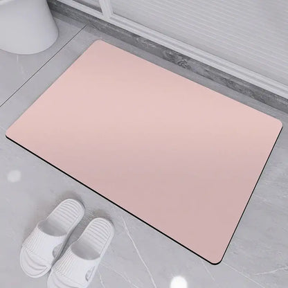 A sleek rectangular pink rubber non-slip bath rug with black border designed for diatom ooze bath use