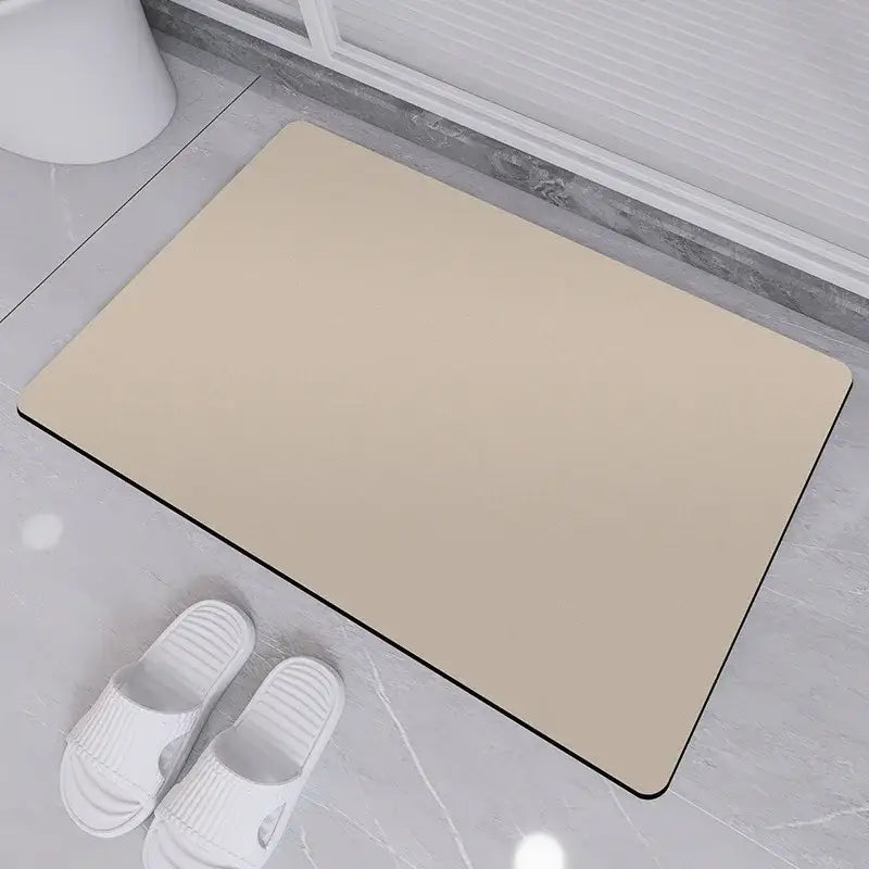 Beige rectangular diatom ooze bath rug with black border designed as a non-slip bathroom mat