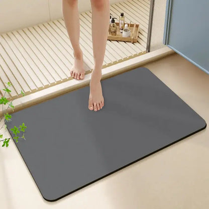 A sleek dark gray rectangular bath rug with rounded corners made of diatom ooze for a non-slip bathroom mat