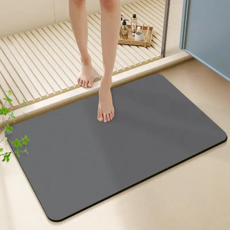A sleek dark gray rectangular diatom ooze bath rug with rounded corners and a smooth non-slip surface for bathroom use