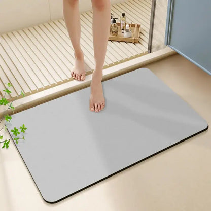 Sleek light gray diatom ooze bath rug with black border and rounded corners for non-slip bathroom use