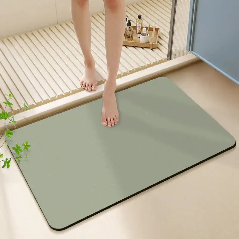 A sleek matte sage green rectangular diatom ooze bath rug with rounded corners and subtle black border non slip mat
