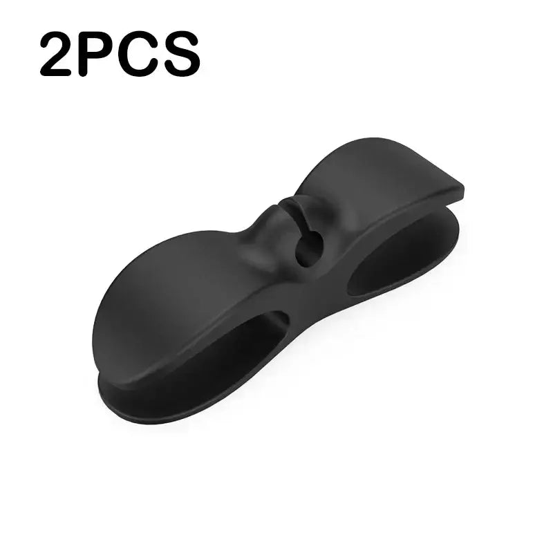 Black plastic cable organizer with sleek bow-shaped design from the sleek silicone decorbites cord winder 3 pack