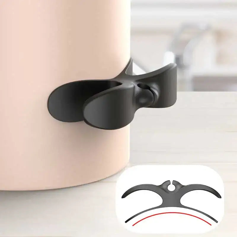Black plastic decorbites cord winder with butterfly design securing pink silicone cable organizer container
