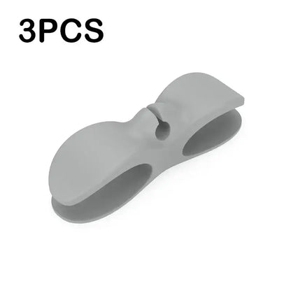 Gray silicone decorbites cord winder cable organizer with sleek bow shape and two open slots for cord management