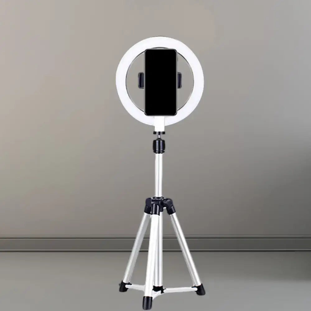 Sleek silver and white circular fill-in lamp mounted on a tripod with smartphone holder for bedroom use