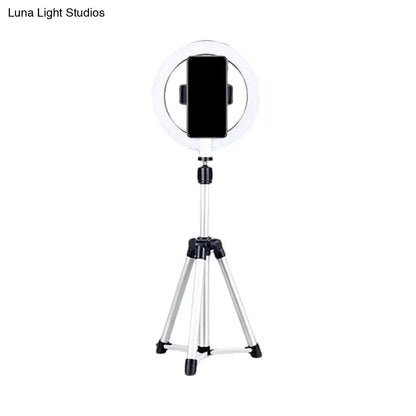 Sleek silver and white circular fill-in lamp with a white ring light mounted on a silver tripod and black phone clamp