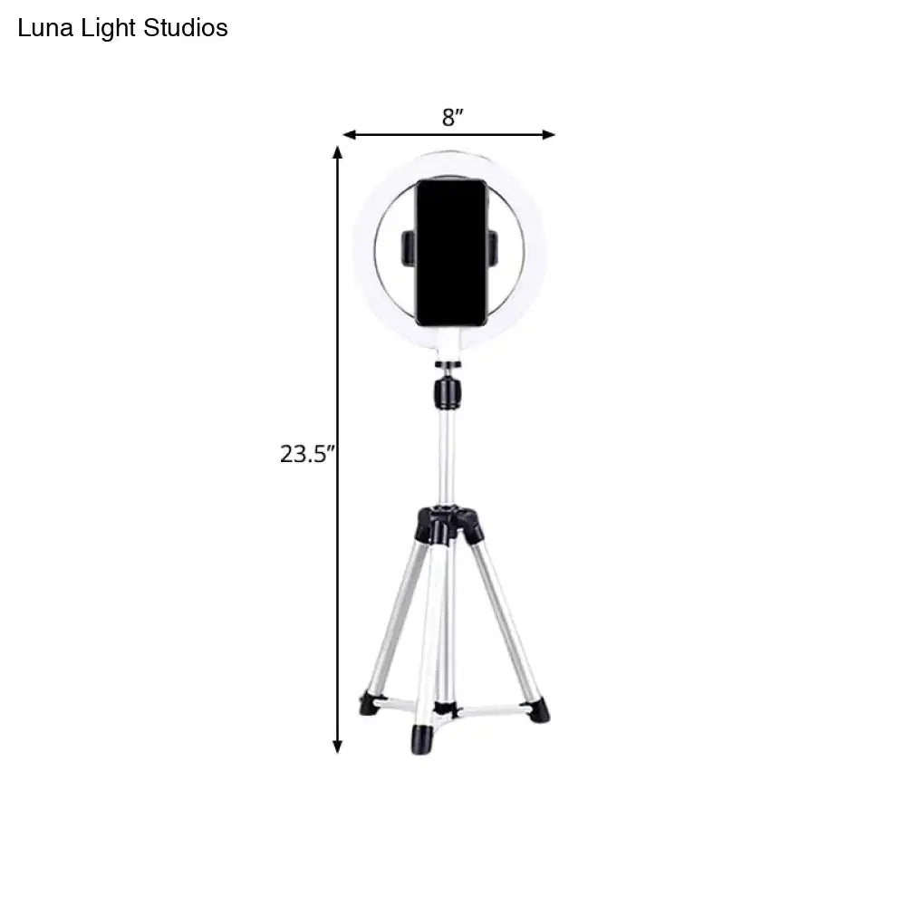 Silver tripod-mounted circular fill-in lamp with 8-inch diameter and black phone clamp for streaming or photography