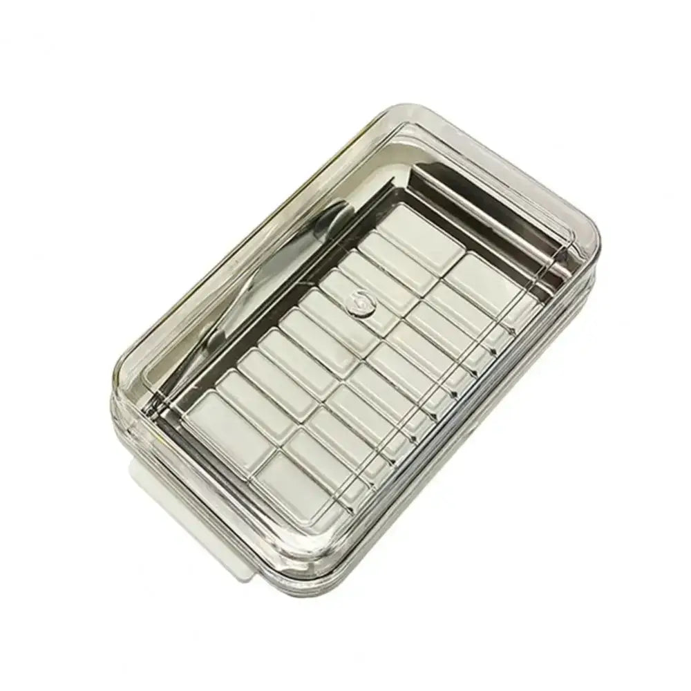 Clear plastic decorbites butter slicer with silver metal grid insert and matching lid in white and stainless steel box