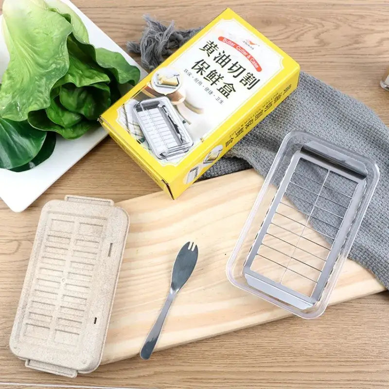 Sleek white and stainless steel decorbites butter slicer with clear plastic cutter box and metal grid insert for storage