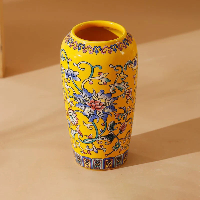 Small ceramic vase in vibrant yellow ceramic with intricate blue pink green floral patterns for office and home decor