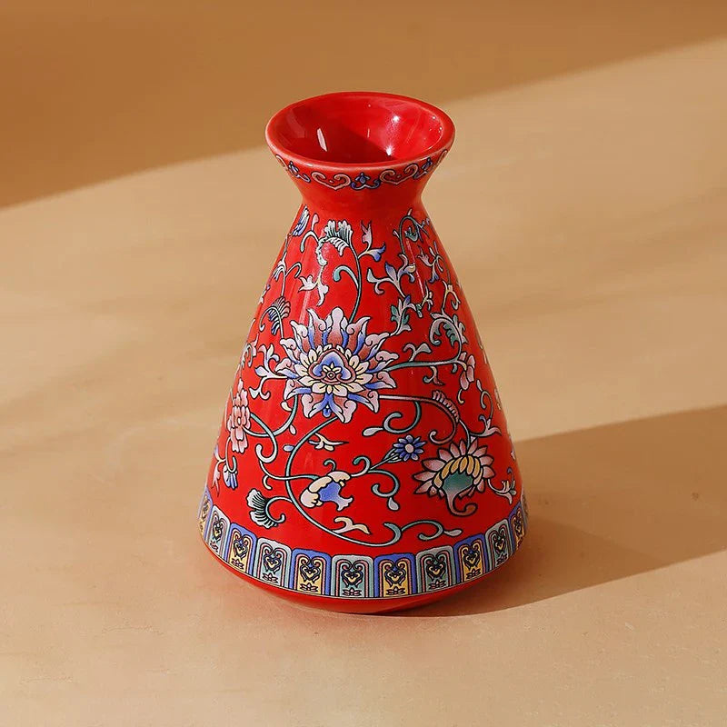 A vibrant red small ceramic vase with blue and white floral patterns enamel glazed porcelain for home and office decor