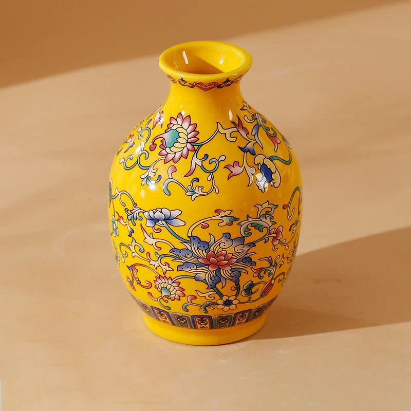 A vibrant yellow ceramic vase with elegant vintage chinese floral and vine patterns in a classic style porcelain design