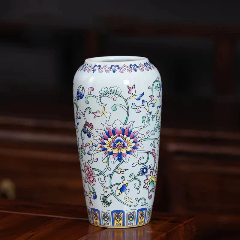 A small white porcelain vase with colorful floral patterns in pink blue and green for elegant home or office decor