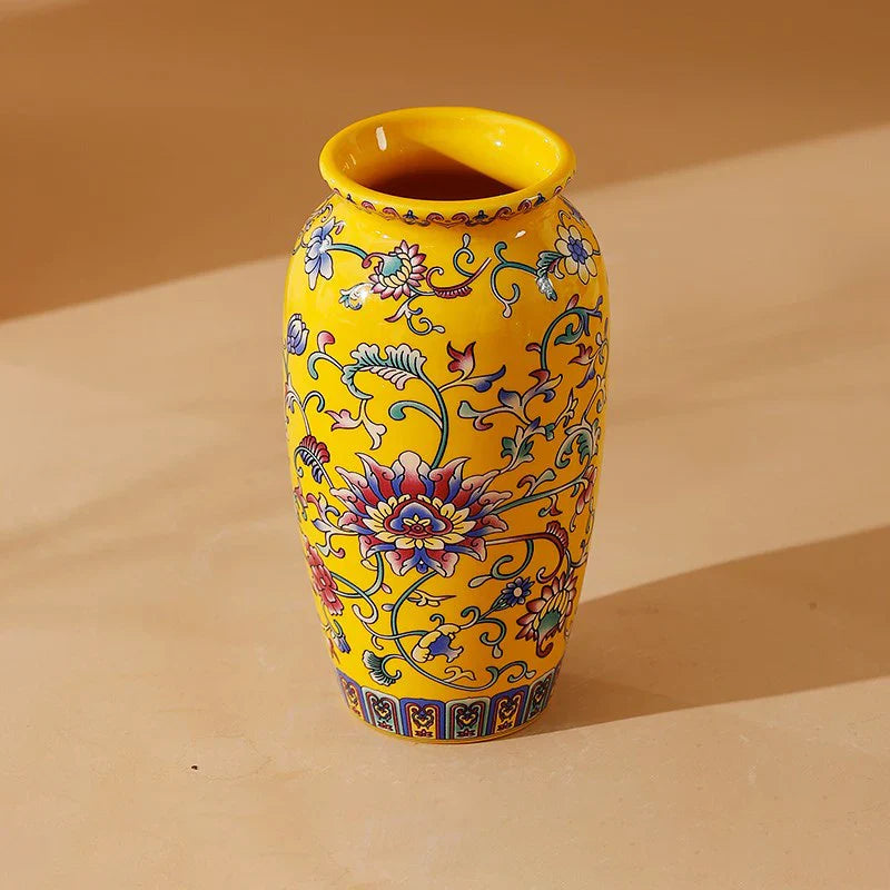 A vibrant yellow small ceramic vase with multicolored floral patterns for elegant vintage Chinese home decor