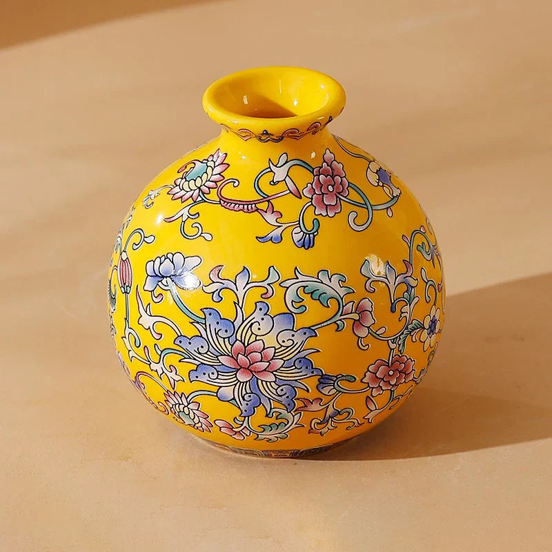 Small ceramic vase in vibrant yellow ceramic with intricate pink blue and white floral patterns for home office decor