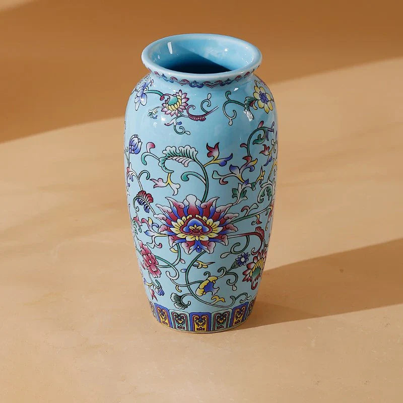 A light blue small ceramic vase with intricate colorful floral patterns made of enamel glazed porcelain for home