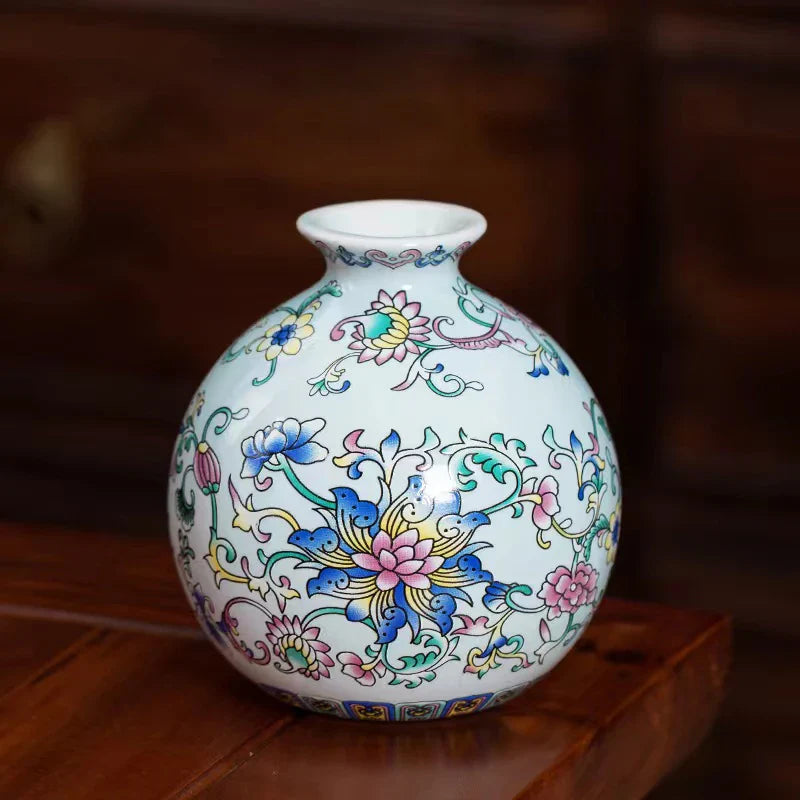 Small ceramic vase in white ceramic with vibrant blue pink yellow floral patterns for elegant home office decor