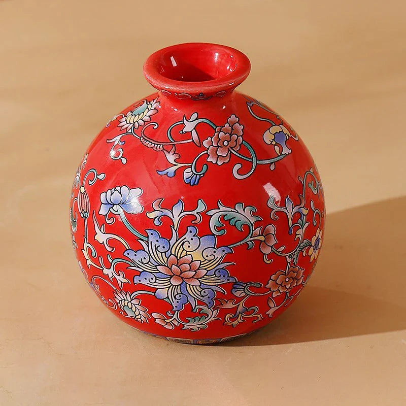 Small vibrant red ceramic vase with intricate blue pink and white floral patterns for elegant vintage home decor