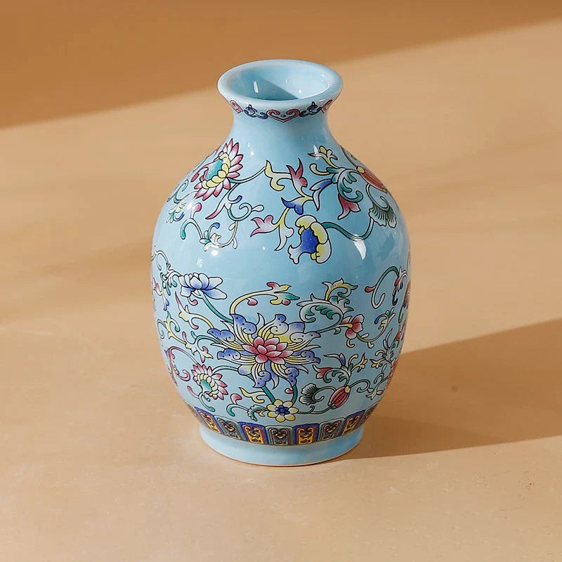 A small light blue ceramic vase with intricate colorful floral patterns for elegant vintage Chinese home decor