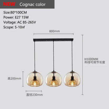 Smoked glass pendant lights trio featuring cognac-colored glass pendant shades with black metal fixtures for dining room