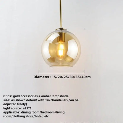 A spherical amber glass pendant light with gold-toned metal fixture and iron finish exposed light source