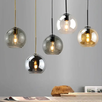 Smoky gray five light glass globe pendant light with iron finish hanging from black and gold cords as light source