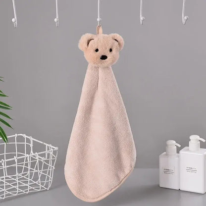 Soft blush-pink plush cartoon bear hand towel with black embroidered eyes made of microfiber for kitchen and bathroom use