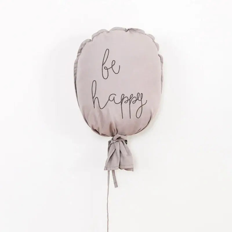 Soft gray cotton balloon wall hanging with be happy embroidery and tied fabric string for kids room decor